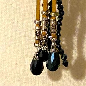 Necklace with royal  blue beads, that sparkle intertwined with tan suede.
